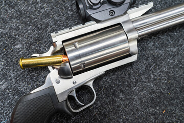 One of the most powerful Magnum revolvers with a red dot in the shooter's hand. Caliber weapon 45-70. Close up. © Dmitri