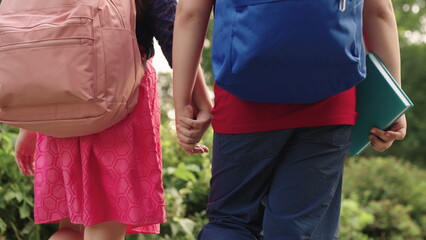 boy girl go school holding hands.students with backpacks their backs. child school friends with school bags rush lesson. hand hand close up. chidhood dream. happy schoolchildren park. kid school.