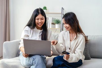 Two women are using laptops and credit cards to pay for purchases and shopping online