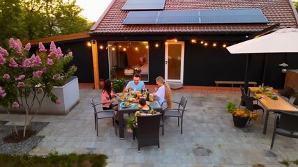 Family enjoying dinner in backyard of sustainable home
