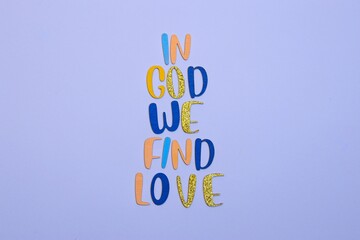 'GOD LOVES ME' arranged vertically in vibrant colors against a light blue background. It's an...