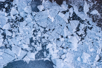 Cracked and broken ice background texture. Frozen lake ice. Ice surface