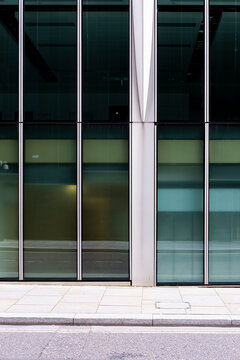 An abstract representation of glass windows in a modern building, highlighting the play of light and shadow, with a minimalist aesthetic and elegant design.