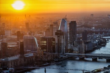 Golden sunset view of the urban skyline of London with River Thames and Blakfriars bridge until...