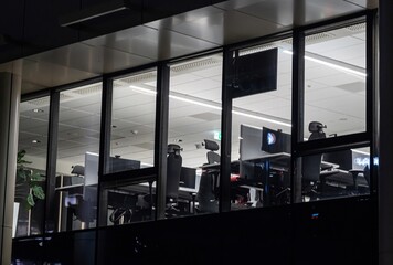 lit windows of a modern office building in the evening