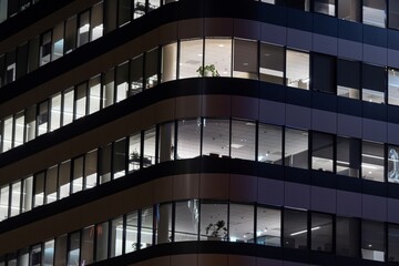 lit windows of a modern office building in the evening