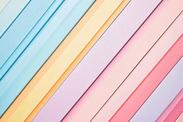 Fototapeta premium Colorful diagonal stripes of pastel paper arranged harmoniously, evoking creativity and design inspiration