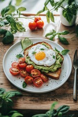 Delicious mashed avocado on sourdough toast topped with poached egg and cherry tomatoes served on a ceramic plate in natural light