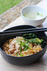 Bakmi ayam or chinese chicken noodle with chili sauce.