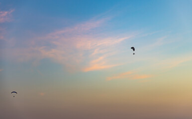 para motors flying in pristine sunset dramatic blue sky at dusk