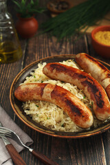 A bowl with Bratwurst and Sauerkraut as side dish - traditional German food	