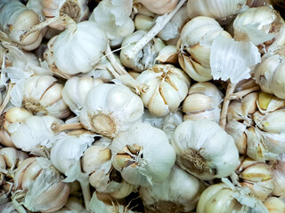 pile of fresh garlic bulbs, showcasing their papery white skin and pungent aroma