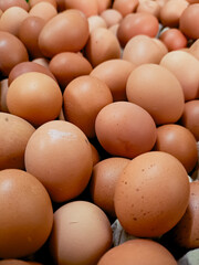 pile of freshly laid brown eggs, showcasing their natural texture and warm tones. Perfect for food photography