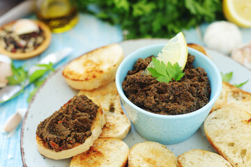 A bowl with tapenade - traditional olive dip in Mediterranean region