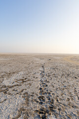white salt flats desert with dramatic bright blue sky at dawn