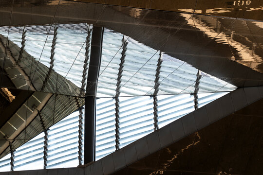 An artistic viewpoint reveals the intricate interplay of light and reflections on shiny surfaces, highlighting the innovative design and architectural beauty.