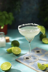 A glass with margarita cocktail with lime