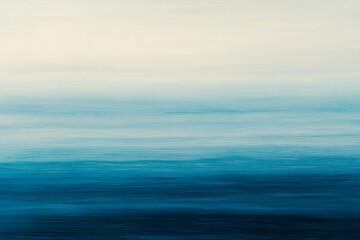 Fototapeta premium Tranquil Seascape with Soft Blue Hues and Gentle Waves Under a Serene Sky at Dusk