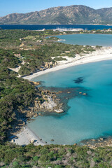 Naklejka premium Porto Giunco ​​beach, with white sand and crystal clear water. Porto Giunco ​​beach and tower in Villasimius, Sardinia, Italy