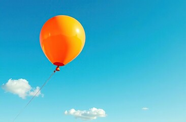 Fototapeta premium An orange balloon drifts against a vibrant blue sky, symbolizing joy, freedom, and the lightness of being