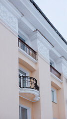 fragment of a residential building with wrought iron balconies