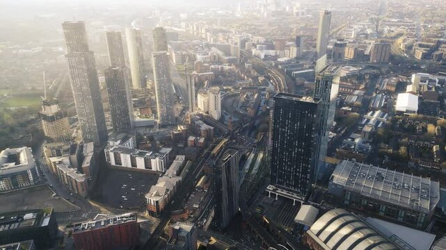 Aerial drone shot across Manchester shot from the west looking east at Deansgate Square, Manchester, UK