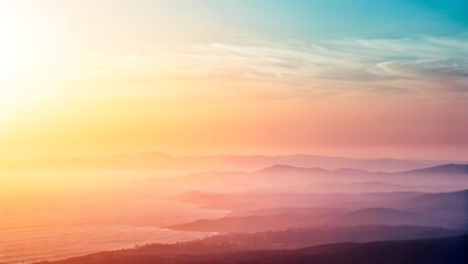 Obraz premium Natural backgrounds. A breathtaking sunrise over misty mountain layers, blending warm and cool tones in a dreamy, peaceful atmosphere.