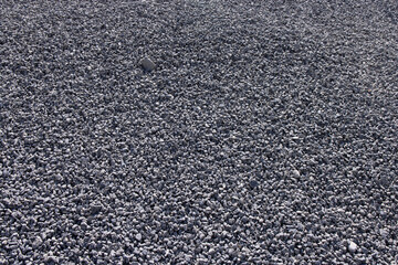 Abstract background of sorted dark grey gravel