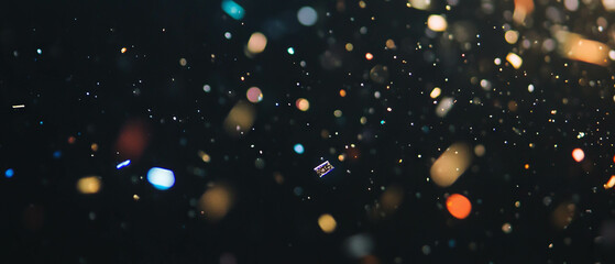 Elegant confetti overlay with gold and silver accents on a dark background for festive occasions