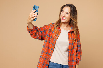Young woman she wear orange shirt casual clothes doing selfie shot on mobile cell phone post photo...