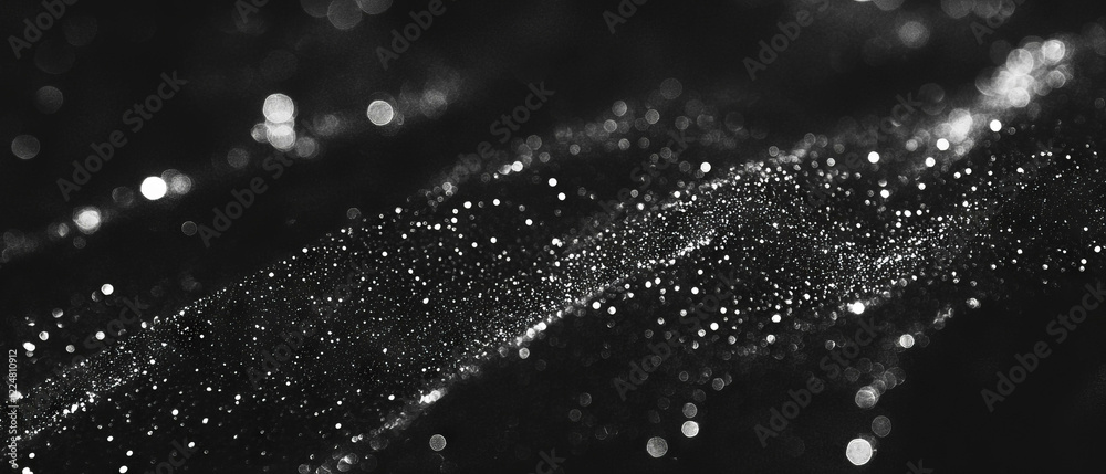 Poster Sparkling glitter texture with floating particles against a dark background