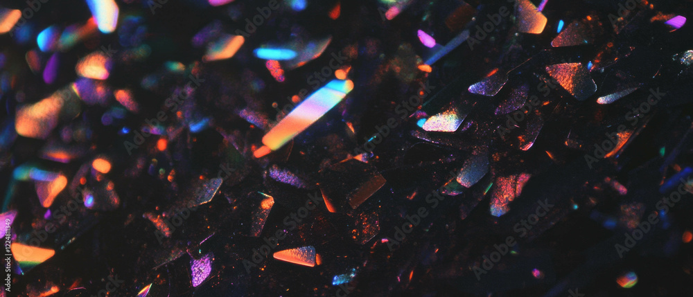 Poster glittering particles create a reflective surface against a dark background