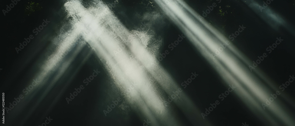 Poster light beams interacting with smoke create dramatic atmosphere against a black background