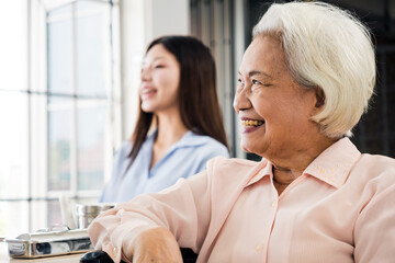 Obraz premium Two Asian women, Senior with white hair and younger, are smiling and engaged in conversation with doctor or general practitioner about the good news of her health in bright clinic. Insurance concept.
