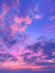 Pastel sunset cloudscape: pink, purple, and blue hues.