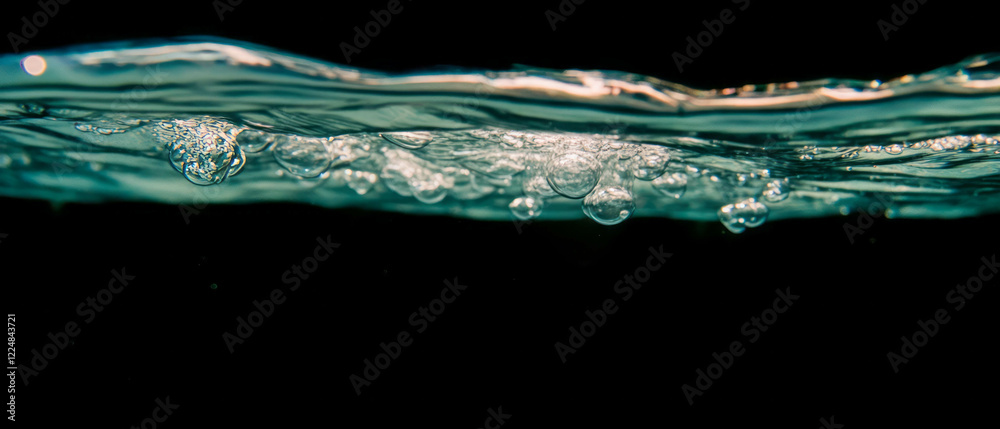 Aufkleber bubbles rising in deep water with a submerged effect against a black background