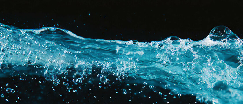 Water bubbles with clusters and clear texture over a black background creating an abstract effect