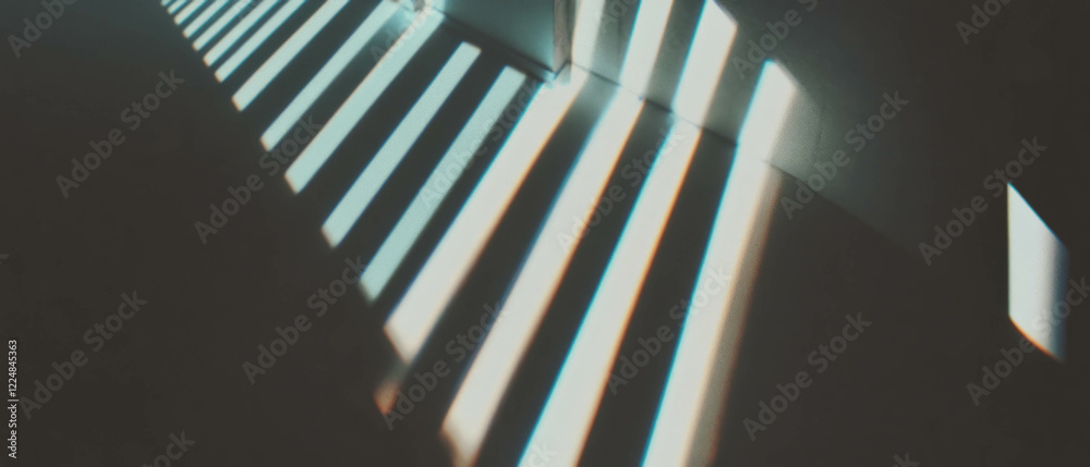 Poster Shadows of window frames create geometric patterns on a dark background