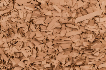 Shredded Brown Paper Creates a Textured Background, Ideal for Craft Projects and Packaging.
