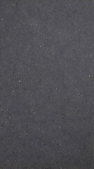 Dark Gray Textured Surface with Tiny Specks and Fine Cracks Creates a Subtle Pattern