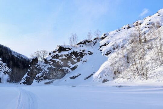 Frozen frozen Malaya Ulba river in the mountains of Eastern Kazakhstan in winter