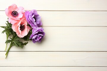 Delicate Pink and Purple Anemones on White Wooden Background Floral Spring Arrangement