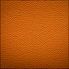 Fototapeta premium Close-up view of an orange textured surface displays a repeating pattern, creating a visually appealing background.