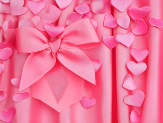 Pink Grosgrain Ribbon Bow Decorates Pink Fabric with Small Hearts Elegantly.