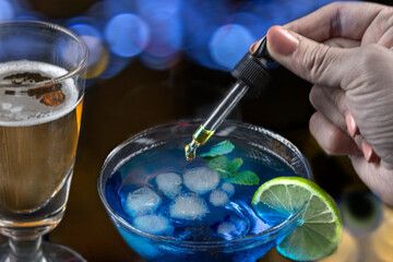 Concept of pouring GHB into a glass with a pipette
