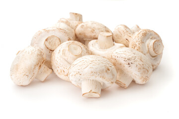 Heap of fresh whole champignons close up on a white background