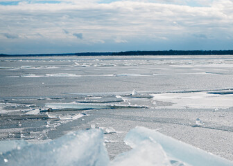 Large chunks of ice on the shore of a frozen lake