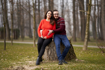 Fototapeta premium Expecting couple embracing outdoors