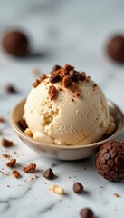 Truffle pieces scattered on top of a scoop of creamy coffee-flavored ice cream on a marble surface, frozen dessert, marble, foodie delight