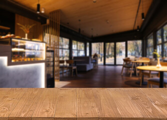 Empty wooden table in restaurant, space for design